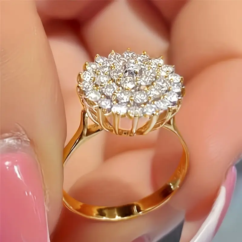 Gold ring with round element made of small stones